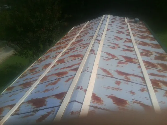 Rusted metal roof panels with new wood purlins before replacement — Storm Damage Roof Repair in Panorama City by Roofing Brothers