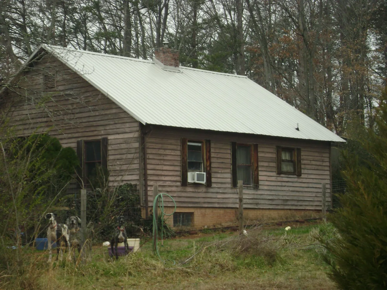 White metal roof on an old wood sided farmhouse, from a Metal Roof Installation job in Panorama City